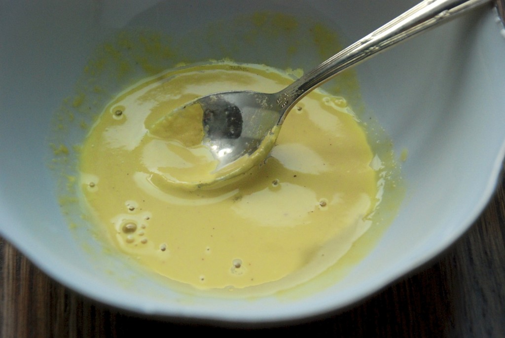 Combine mustard and vinegar with a spoon
